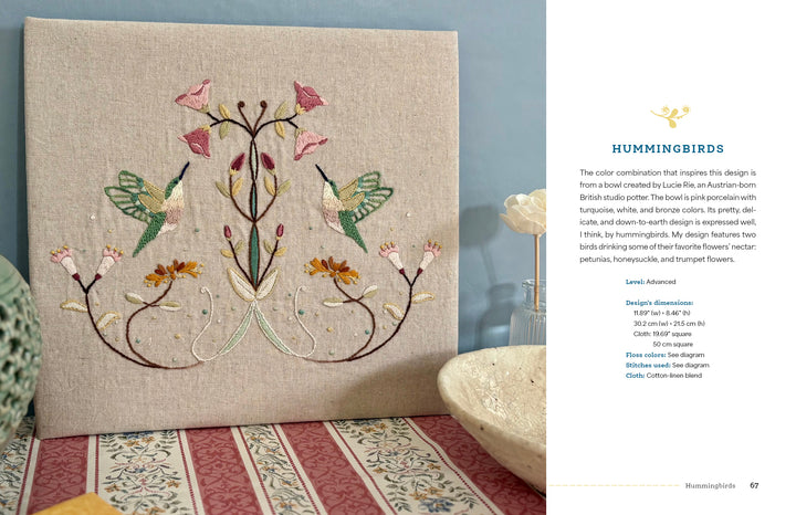 Wild Embroidery" by Schiffer Publishing, Ltd. features two green and pink hummingbirds facing each other among pastel floral and leaf patterns on beige fabric, displayed upright for a nature-inspired touch.
