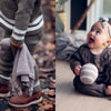 A split image: left, a child outdoors holds a knitted bunny toy; right, a baby in Nordic knitwear sits indoors with striped ball and bunny. The words "Baby Knits from Norway – Schiffer Publishing, Ltd." appear above.