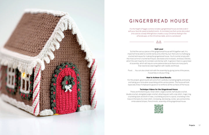 A crocheted gingerbread house with candy cane details sits on a white surface. Next to it, a page from Schiffer Publishing, Ltd.’s Cozy Christmas Crochet highlights skill level and techniques for festive holiday crochet projects.