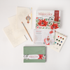 Watercolor the Easy Way Paint-Your-Own Watercolor Cards Christmas by Schiffer Publishing, Ltd. includes a palette, pencil, instructions, green envelope, card with poinsettias, and themed watercolor paper—everything for festive holiday cards.