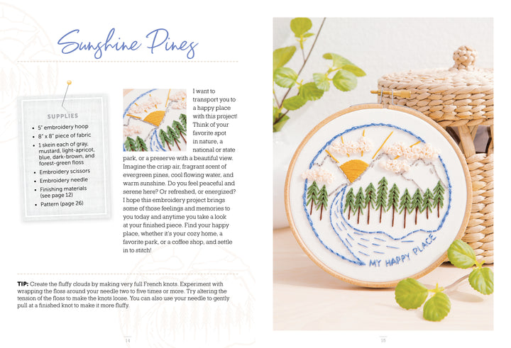 The Sunny Stitches Embroidery Kit Sunshine Pines from Schiffer Publishing, Ltd. displays a hand-embroidered landscape with pines, a river, sun, and clouds. A woven basket and green plant are nearby; supplies and instructions are shown on the left.