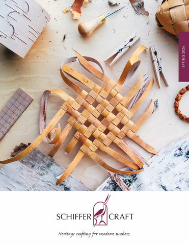 A woven basket in progress sits on a worktable with wood strips, crafting tools, and a ruler. The image features the Schiffer Craft logo and the words Heritage crafting for modern makers.