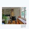 A Gracious Living room by Schiffer Publishing, Ltd. features accessible design with a wheelchair, stone fireplace, couch, built-in window seat, large windows for natural light, and warm wooden floors for comfort.