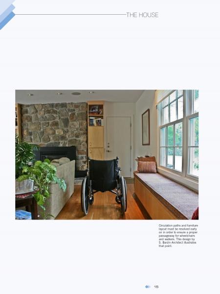 A Gracious Living room by Schiffer Publishing, Ltd. features accessible design with a wheelchair, stone fireplace, couch, built-in window seat, large windows for natural light, and warm wooden floors for comfort.