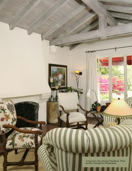 A cozy living room with striped and floral chairs, a fireplace, and garden views with pink flowers reflects the Mediterranean charm featured in *Lilian J. Rice* by Schiffer Publishing, Ltd.