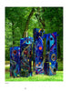 A Universe of Metal Sculpture" by Schiffer Publishing, Ltd. features vibrant abstract metalwork—tall, rectangular blocks painted in swirling blue, red, orange, and yellow—standing on grass in a lush, wooded park.