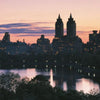 The cover of "Windows on Central Park" by Schiffer Publishing, Ltd. features tall buildings silhouetted at dusk with glowing windows, set against a pink and purple sky reflected in calm water amid the New York City landscape.