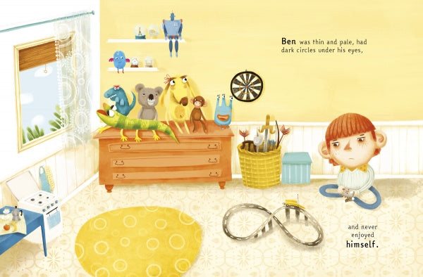 A sad, pale boy with red hair sits in a yellow, toy-filled room on the cover of King of Boredom by Schiffer Publishing, Ltd., surrounded by plush animals and toys—his uniqueness sets him apart, but he doesn’t seem to enjoy himself.