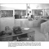 Black-and-white photo of the Alcatraz Island prison administration office, featured in Schiffer Publishing, Ltd.'s "Ghosts of Alcatraz," shows a typewriter, desk, shelves, and equipment, evoking the site's haunted, storied history.