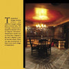 The Wine Cellar Design by Schiffer Publishing, Ltd. features a luxury space with a round wooden table, four chairs, wine racks, dark tiled floors, dim lighting, and an informational panel for an elegant home wine cellar setting.