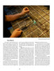 Practicing precise metalworking, a person uses a handheld torch to solder thin metal rods in a grid, as featured in "A Universe of Metal Sculpture" by Schiffer Publishing, Ltd., creating intricate sculpture techniques in a well-lit workspace.