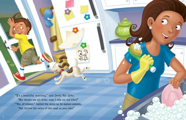 A smiling woman washes dishes as a boy, eager to read Bicycling Rules of the Road by Schiffer Publishing, Ltd., runs toward the door with his helmet. Their playful dog chases him through a bright kitchen with a “COOKIES” jar on the counter.