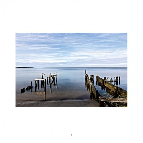 A wooden pier reaches into peaceful waters, showcasing the serene beauty of Chesapeake Bay—a featured scene in Schiffer Publishing, Ltd.'s "Maryland Landscapes.
