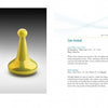 On the left, four metallic, pawn-shaped glass sculptures in green, silver, orange, and gold appear. On the right are three tall, pointed contemporary glass pieces. Featured in "Art Glass Today 2" by Schiffer Publishing, Ltd.