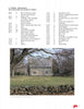 A historic stone house with a gray roof stands behind leafless trees, grass, and a low wall. Schiffer Publishing, Ltd.'s "Connecticut by Bicycle" is perfect for discovering scenic Connecticut bike routes in this peaceful, overcast setting.