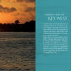 A sunset over calm ocean waters with a sailboat on the left and silhouetted trees on the horizon. On the right, blue background text describes Schiffer Publishing, Ltd.'s "101 Things to Do in Key West," a Florida island paradise guide.