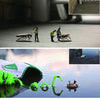 ARTtitude by Schiffer Publishing, Ltd. features a collage of miniature workers with giant insects, a shoe with green laces in water, and small figures rafting beside it—an imaginative, surreal scene inspired by contemporary graphic arts.