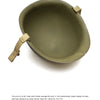 A top-down image of "The M-1 Helmet of the World War II GI" by Schiffer Publishing, Ltd. shows the green helmet with khaki chin straps on a white background, with text below about its WWII manufacturing, combat use, and cost.