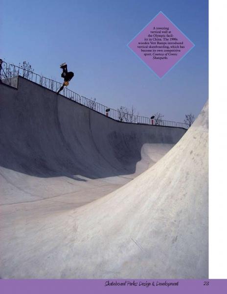 A skateboarder does a trick on the curved edge of a large Skateboard Parks facility by Schiffer Publishing, Ltd., under clear skies. Shadows stretch across the smooth concrete and a tall fence lines the park’s top edge.