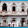 Havana Forever by Schiffer Publishing, Ltd. captures a pale blue, weathered building with open windows and balconies—classic Havana style. Clothes dry outside while two women chat above and another tends laundry below.