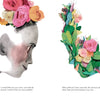 A stylized illustration inspired by the Frida Kahlo children's book "The Two Fridas" from Schiffer Publishing, Ltd. features a profile with colorful flowers and leaves on the head, plus a floral cluster and short text beneath both images.
