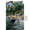 A dog stands in a stream, surrounded by beautiful landscape design and tranquil water features from "Water Gardens and Natural Pools" by Schiffer Publishing, Ltd.