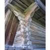Close-up of a traditional log house corner from "Wood in Traditional Architecture" by Schiffer Publishing, Ltd., showing detailed carpentry, interlocking logs, skilled joinery, and visible roof structure.
