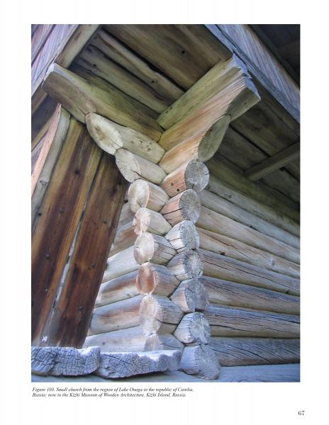 Close-up of a traditional log house corner from "Wood in Traditional Architecture" by Schiffer Publishing, Ltd., showing detailed carpentry, interlocking logs, skilled joinery, and visible roof structure.