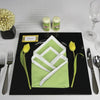 Set a chic table with silverware, glasses, a black plate, and a folded green and white napkin—framed by yellow tulips—as featured in Schiffer Publishing, Ltd.'s Creative Napkins and Table Settings. A name card and yellow arrangement complete the look.