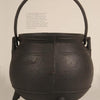 The book "Early American Cast Iron Holloware 1645-1900" by Schiffer Publishing, Ltd. showcases sturdy, antique cauldrons with three legs and curved handles, ideal for hearth cooking, against a plain background.