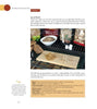 A page from Home Smoking Basics by Schiffer Publishing, Ltd. shows a wooden board with various wood chips on a grill, bags of chips behind, details on smoking meat and wood types, and a yellow tip box at the lower left.