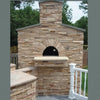Try new gourmet recipes with The Ultimate Wood-Fired Oven Book by Schiffer Publishing, Ltd., inspired by outdoor ovens with rounded arch openings and stacked stonework, perfect for patios surrounded by greenery and fencing.