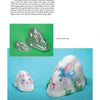 Sugar Art by Schiffer Publishing, Ltd. features two metallic rabbit molds and two crafted sugar rabbits—one with blue ribbon and flowers—highlighting cake decorating and sugar artistry on a light blue background.