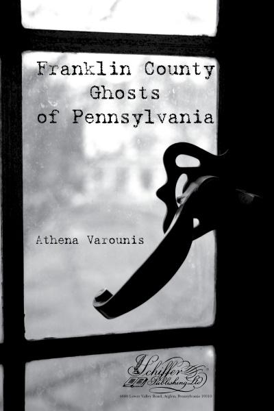A black-and-white cover with an old window latch evokes the paranormal in Franklin County Ghosts by Schiffer Publishing, Ltd. The title and publisher appear over the glass, hinting at eerie tales within.