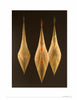 Three elongated, symmetrical fiber sculptures with translucent golden layers and colorful accents are featured as striking textile art in "Fiber Art Today" by Schiffer Publishing, Ltd.