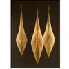 Three elongated, symmetrical fiber sculptures with translucent golden layers and colorful accents are featured as striking textile art in "Fiber Art Today" by Schiffer Publishing, Ltd.