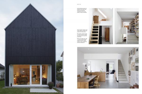 Contemporary Home Design by Schiffer Publishing, Ltd. showcases a sleek black exterior and vibrant minimalist interiors—featuring a wooden staircase, open kitchen, dining space, bookshelves, and crisp white walls for single-family home inspiration.