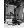 Black and white photo from 1912 of an ornate canopy bed with intricate ironwork at Castel SantAngelo, Rome. Featured in "Decorative Ironwork of Italy" by Schiffer Publishing, Ltd. Antique décor reflects blacksmith-inspired design.