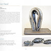 A page from Schiffer Publishing, Ltd.'s "Ironwork Today 4" features metal sculpture by Lauren Head, with a main image of an abstract silver piece and, below it, two organic-textured silver belt buckles.