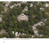An aerial view of a circular building with a white cross and dome, nestled among trees and houses—an iconic scene captured in "Martha's Vineyard Perspectives" by Schiffer Publishing, Ltd.