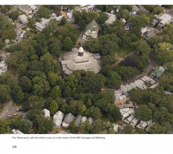 An aerial view of a circular building with a white cross and dome, nestled among trees and houses—an iconic scene captured in "Martha's Vineyard Perspectives" by Schiffer Publishing, Ltd.