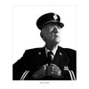 A serious elderly man in formal firefighter attire looks upward, holding his coat. "Local Heroes" by Schiffer Publishing, Ltd. captures the dedication of volunteer firemen in striking black and white photography.
