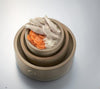 Cooking for Dogs by Schiffer Publishing, Ltd. features recipes like a layered clay pot with cooked chicken, white rice, and carrots—a great homemade dog treat to boost your dog's nutrition.