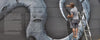 A person stands on a ladder painting a metallic swirl mural on a wall, face blurred, with text to the left. Mural inspired by 2Create from Schiffer Publishing, Ltd.—a striking piece of street art.