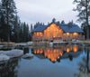 “The Best of Today’s Log Homes” by Schiffer Publishing, Ltd. features classic log home designs, including scenic log cabins set against serene lake backdrops.