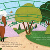 A red fox stands beneath a green trellis amid poppies and trees, inspired by Monet’s Giverny. A butterfly flutters above. The text reads: In the middle of a garden... lived a little red fox. From "A Colorful Tail" by Schiffer Publishing, Ltd.