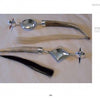 Two silver and deer antler rattles from "Masters of Contemporary Indian Jewelry" by Schiffer Publishing, Ltd. rest on a white surface—one with a circular top and light tassel, the other with a diamond-shaped top and dark tassel.