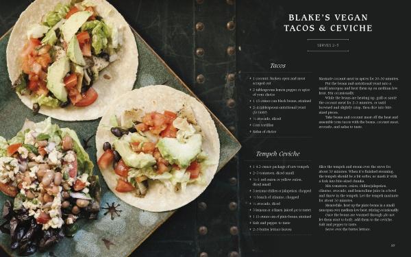 A dark plate holds three vegan tacos with diced tomatoes, lettuce, avocado, black beans, and tempeh. Beside it is Schiffer Publishing, Ltd.’s "Knives and Needles," a cookbook featuring Blake’s home recipes and vegan ceviche.