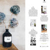 Two-page magazine spread for "Home Story" by Schiffer Publishing, Ltd.: left page features dried hydrangeas in a dark Aqua vase with "Best of Interiors" text; right page spotlights Schöner Wohnen’s top German interior projects and design competition.