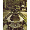 Cascading water flows through a lush garden framed by tall palms, evoking classic Hollywood glamour—just like the settings featured in "More Hollywood Homes" from Schiffer Publishing, Ltd.